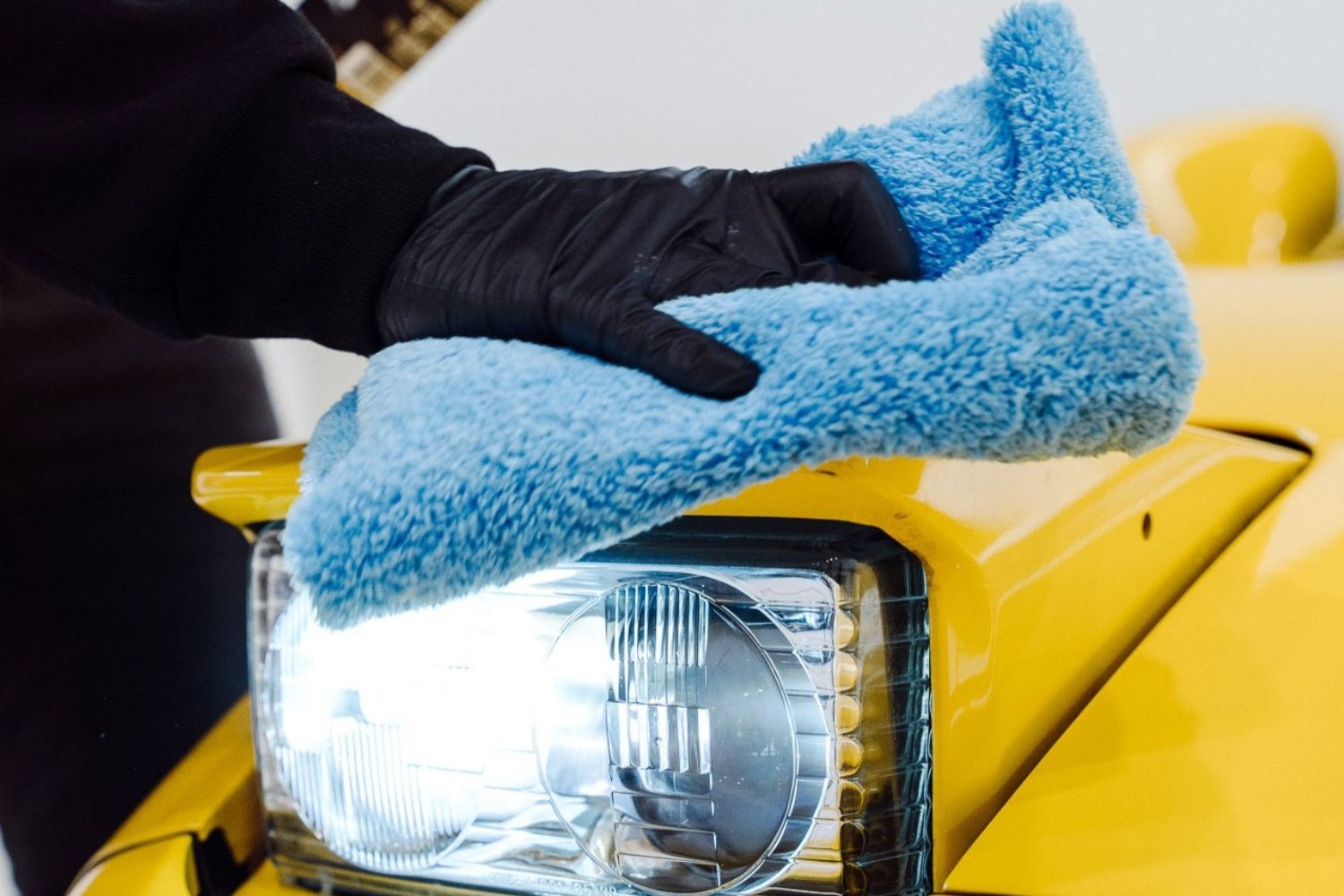 Microfibre Towel On a Yellow Car The Detail Store